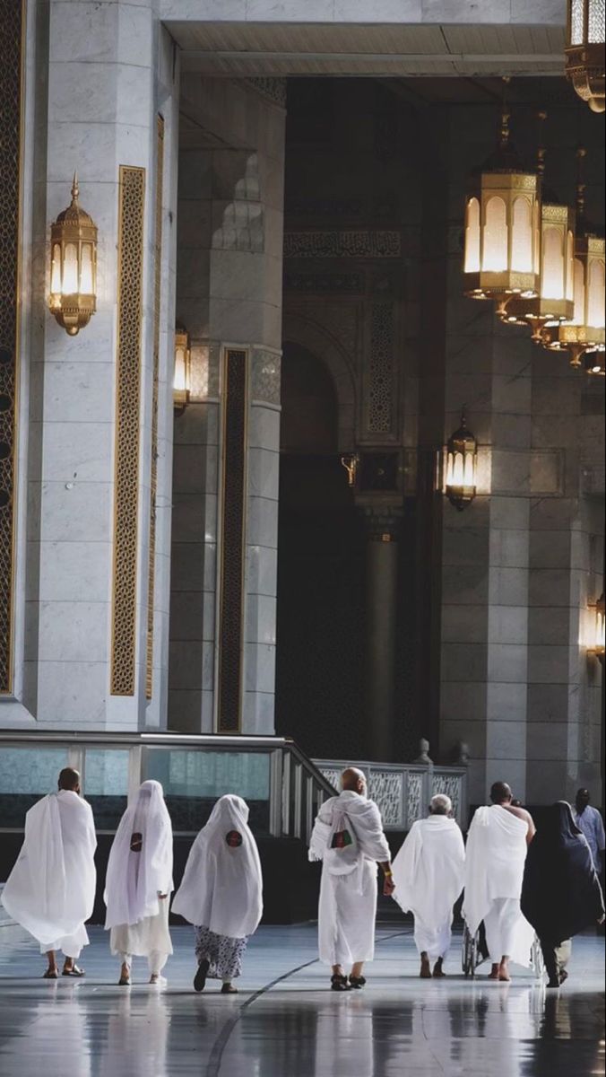 Pilgrims in ihram walking through the Masjid al-Haram
